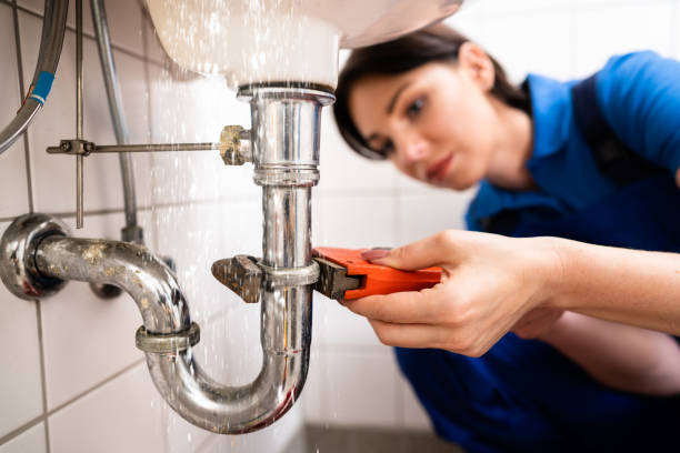 plumber fixing and repairing sink pipe water leak